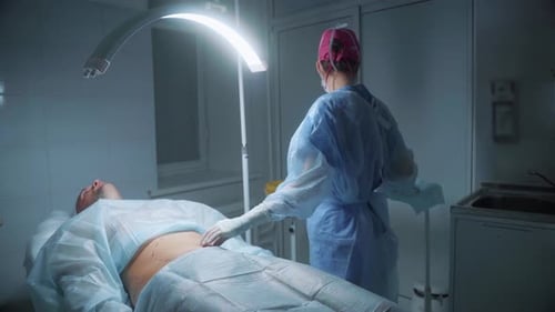 Doctor Examines Patient in Surgical Room