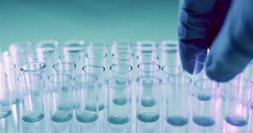 Closeup, drop and test tube with hands for chemical in study, analysis or pharmaceutical development