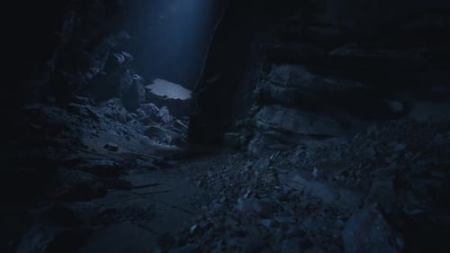 Dark Cave Exploration Revealing Rocky Terrain and Distant Light