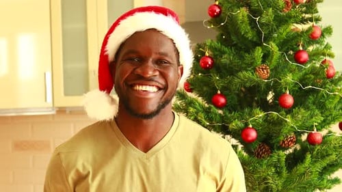 Man Smiling Wearing Santa Hat at Christmas