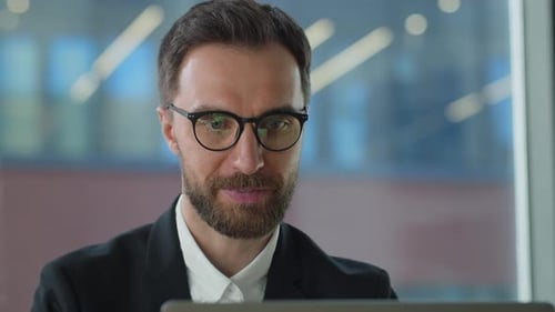 Man with Beard Working on Laptop Close Up