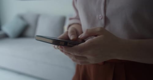 Close Up of Young Adult Using Smartphone Indoors
