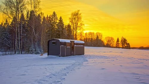 Colorful Sky Over Cabin House Near Trees In Forest During Winter Season, Sunset to Night Timelapse.