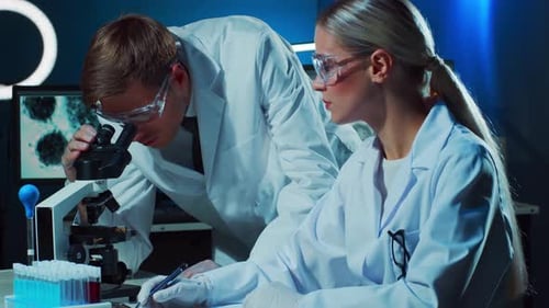 Medical Scientists Working in Lab Doctor Teaching Intern to Make Blood Analyzing Research Laboratory