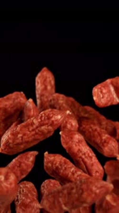 Mini Salami Fly and Fall on a Black Background Filmed on a Highspeed Camera at 1000 Fps