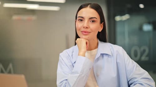 Professional Woman Smiling with Confidence in Office