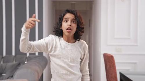 Angry Indian kid boy fighting with someone