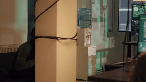 Person in Hooded Jacket Works at Computer