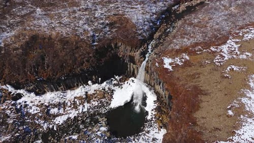 Cascading water aerial top down view Svartifoss Waterfall Iceland Black Hidden Iced landscape, aroun