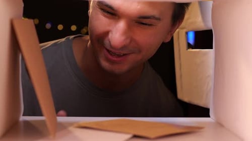 View From Inside the Mailbox a Man Smiles and Takes Letters From the Mailbox