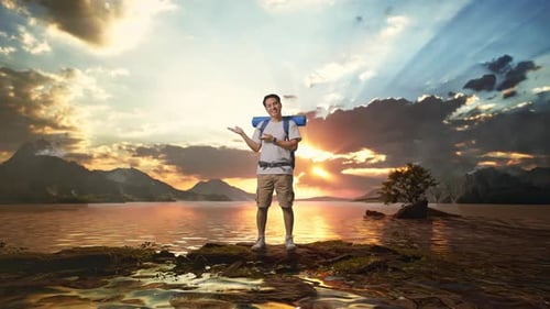 Full Body Of Asian Male Hiker Smiling And Pointing To Side At A Lake