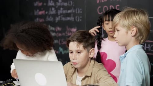 Enthusiastic Children Learning Computer Coding in Classroom