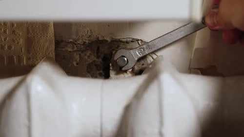 Wrench Tightening Nut on Radiator Pipe