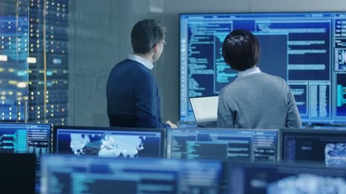 Data Specialists Reviewing Code in Modern Tech Office