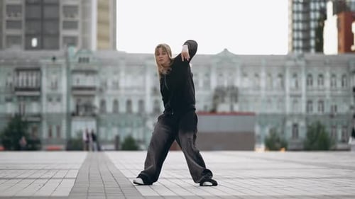 Young Woman Dancing Hip Hop on the Street