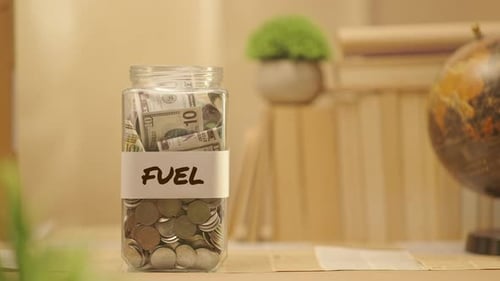 PERSON SAVING MONEY FOR FUEL