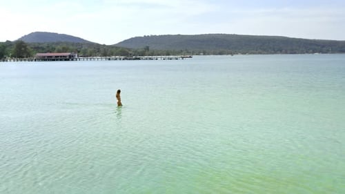 Beautiful Female Model Walks In Water On Tropical Island, Cambodia.