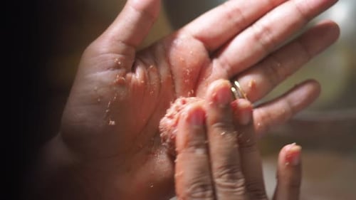 Hands Forming a Meatball for Cooking Preparation