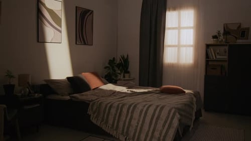 Empty Cozy Bedroom with Warm Sunlight Shining through Window