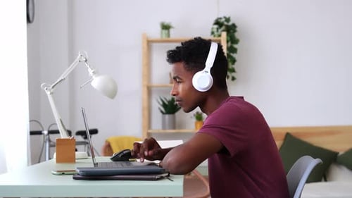 Young Adult Working on Laptop at Home