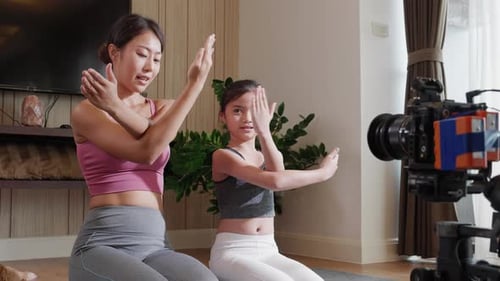 Woman and Child Stretch Arms During At-Home Yoga