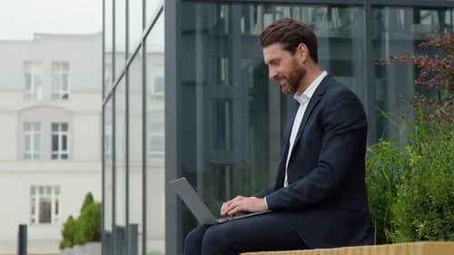 Smiling Positive Caucasian Mature Business Man Typing Laptop in City Remote Working Middleaged Male