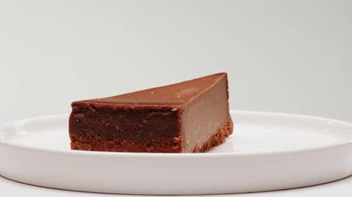 Delicious Chocolate Cheesecake Slice on a White Plate