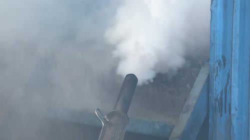 Close-up of Smoke-Emitting Machine With Thick White Vapor