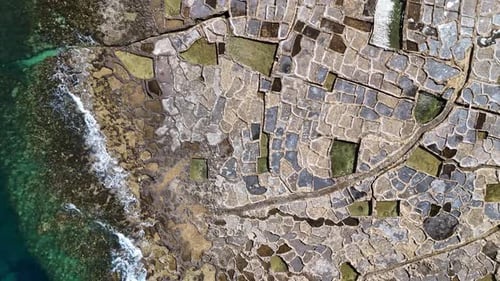 Drone view of Xwejni Salt Pans in Gozo Island, Malta