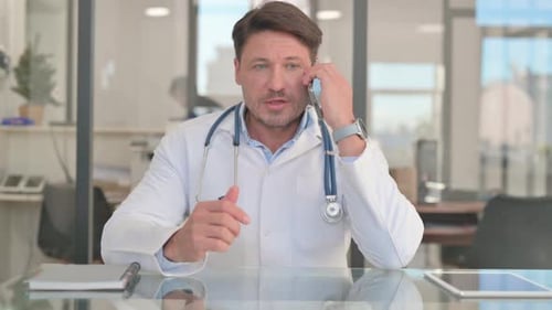 Doctor Talking on Phone in Modern Office