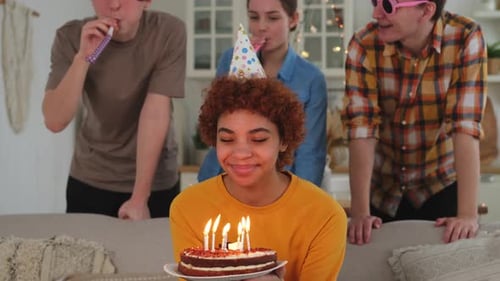 Friends Celebrating Birthday with Cake and Candles