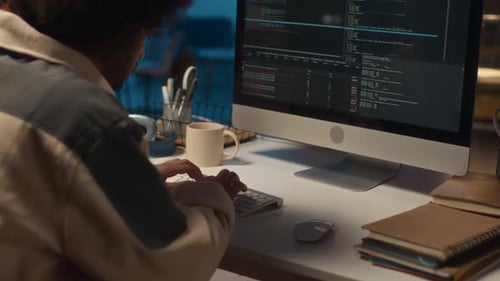 Man Coding Late at Night at Computer Desk