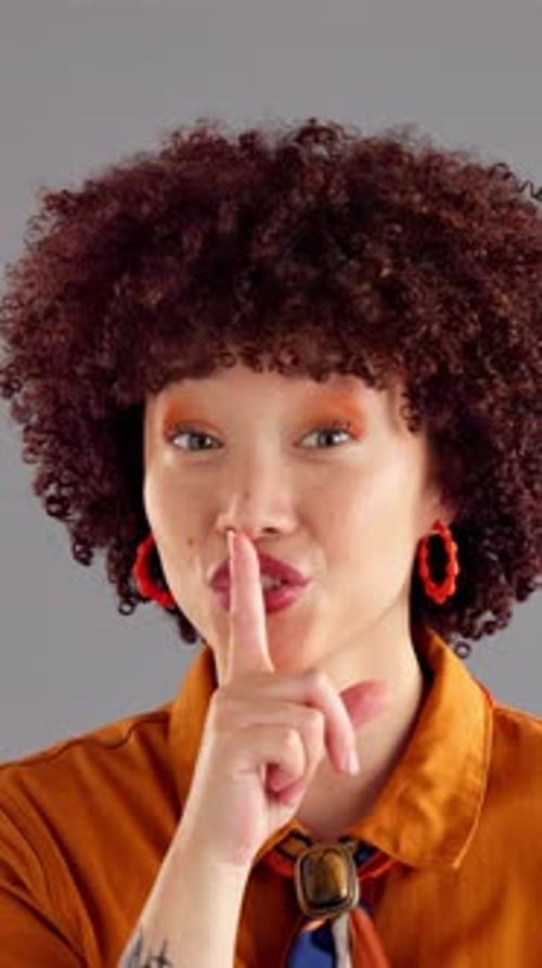 Woman, face and finger to lips for secret, confidential or privacy gesture with wink