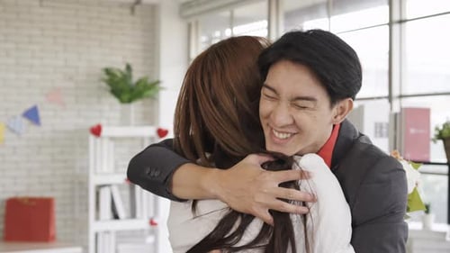 Romantic Man Embracing Woman with Bouquet of Flowers