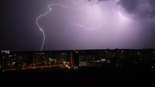 Flashes of Lightning Over the Night City Severe Thunderstorm with Thunder