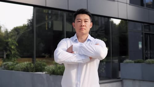 Successful Male Business Man Standing Near Modern Grey Glass Office Center