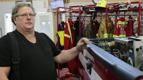 Portrait Confident Tough Male Firefighter in Fire Station 5054 Years