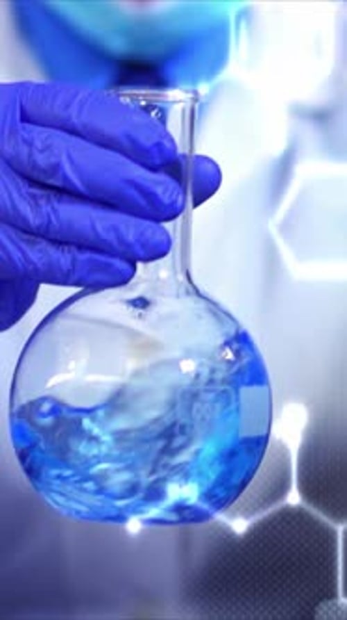Scientist Holding Flask With Blue Liquid in Lab