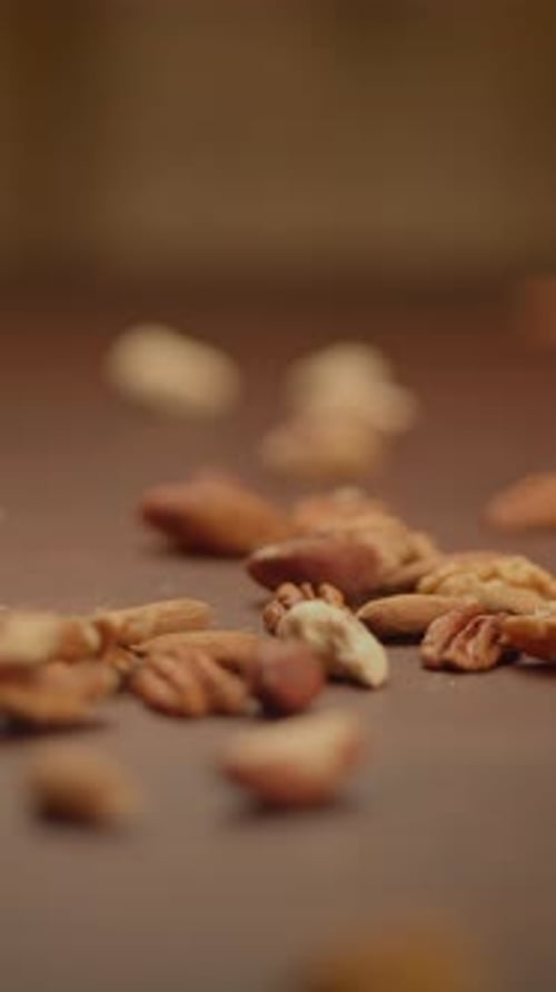 A CloseUp View of Various Raw Nuts Spread Out on a Rustic Wooden Surface to Enjoy