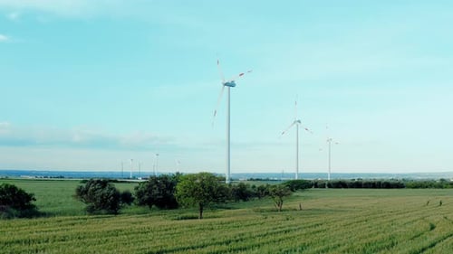 Aerial view of wind power, windmill, energy production, eco-energy in a beautiful green nature.