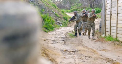 Front view of Biracial military soldiers rifle training in fields during military training 4k