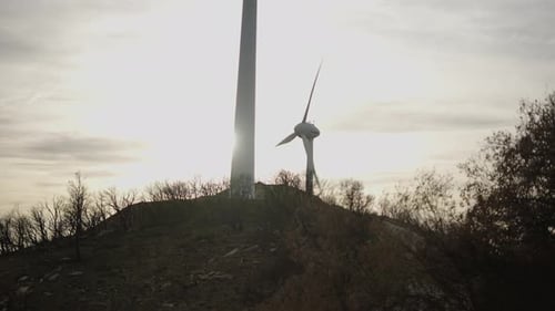 Handheld Shot of Wind Turbines at the Mountain During Sunset