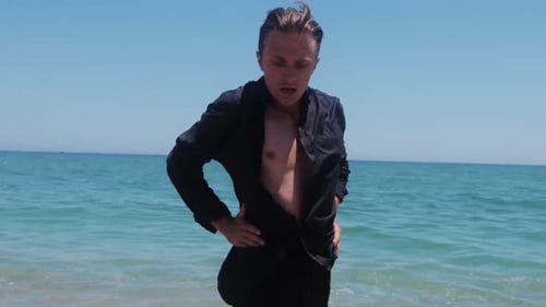 Young Adult Practicing Martial Arts on the Beach