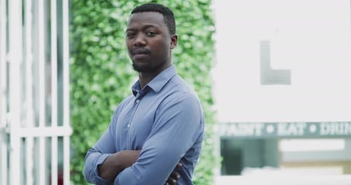 Confident Man Standing with Arms Crossed in City