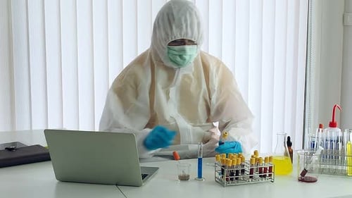 Researcher or scientists loads liquid sample into test tube in laboratory.