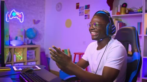 African American Man Playing Action Video Games on Computer Stream Online Broadcast Live Gaming