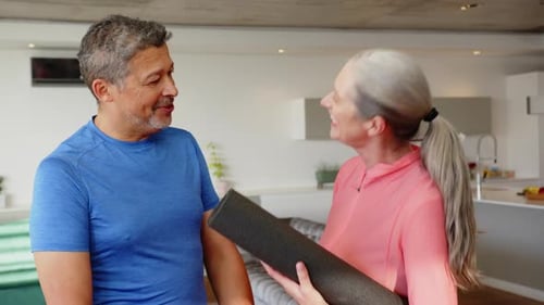 Mature Couple Talking Before Yoga in Modern Home