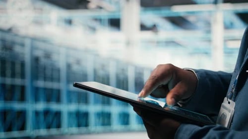 Close Up of Data Center Engineer Using AI Software on Tablet