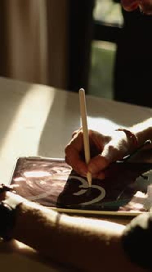 Artist Drawing on Digital Tablet in Bright Sunlight