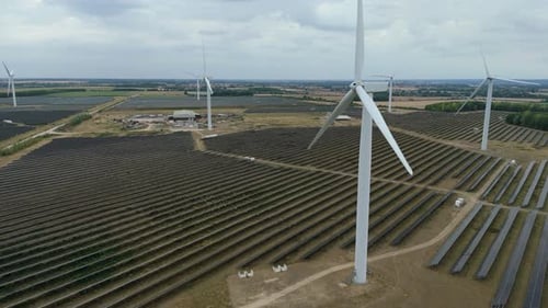 Aerial View of Solar Panels and Wind Turbines